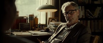 Movie still from “August: Osage County” (2013), directed by John Wells – An older man sitting at a desk in front of a window; Close Up shot, Over the shoulder angle