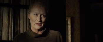 Movie still from “August: Osage County” (2013), directed by John Wells – An older woman in a dark room looking at the camera; Close Up shot, Over the shoulder angle