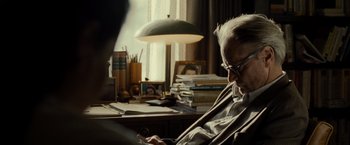 Movie still from “August: Osage County” (2013), directed by John Wells – An older man sitting at a desk in front of a window; Close Up shot, Over the shoulder angle