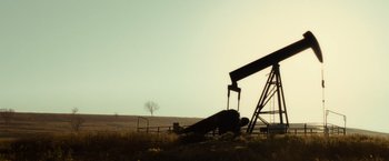 Movie still from “August: Osage County” (2013), directed by John Wells – An image of an oil well in the middle of nowhere; Extreme Wide shot, Low angle