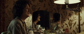 Movie still from “August: Osage County” (2013), directed by John Wells – A woman sitting in front of a mirror in a room; Close Up shot, Over the shoulder angle