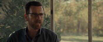 Movie still from “August: Osage County” (2013), directed by John Wells – A person wearing glasses near a window; Close Up shot, Over the shoulder angle