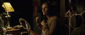 Movie still from “August: Osage County” (2013), directed by John Wells – A woman sitting in front of a mirror in a room; Medium shot, Over the shoulder angle