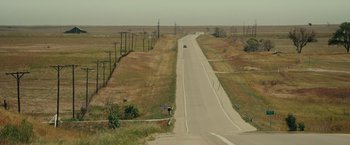 Movie still from “August: Osage County” (2013), directed by John Wells – An image of an empty road in the middle of the day; Extreme Wide shot, High angle