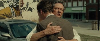Movie still from “August: Osage County” (2013), directed by John Wells – Two men are hugging each other in the street; Close Up shot, Over the shoulder angle