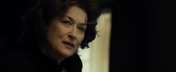 Movie still from “August: Osage County” (2013), directed by John Wells – An older woman looking at the camera while sitting in a chair; Close Up shot, Over the shoulder angle