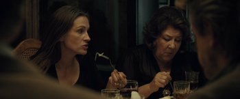 Movie still from “August: Osage County” (2013), directed by John Wells – Two women sitting at a dinner table eating food; Close Up shot, Over the shoulder angle
