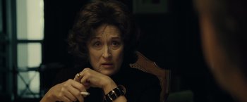 Movie still from “August: Osage County” (2013), directed by John Wells – An older woman sitting in a chair with a cigarette in her hand; Close Up shot, Over the shoulder angle