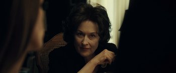 Movie still from “August: Osage County” (2013), directed by John Wells – An older woman sitting in front of a window; Close Up shot, Over the shoulder angle