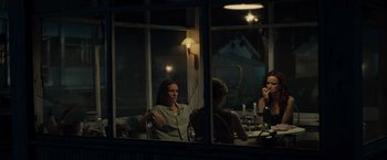Movie still from “August: Osage County” (2013), directed by John Wells – A group of people sitting at a table in front of a window; Medium shot, Over the shoulder angle