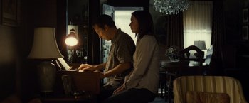 Movie still from “August: Osage County” (2013), directed by John Wells – A man and a woman are playing a piano together; Medium shot, Low angle