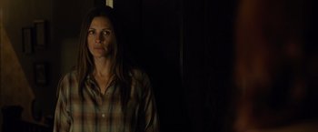 Movie still from “August: Osage County” (2013), directed by John Wells – A woman standing in a dark room with her head turned to the side; Close Up shot, Over the shoulder angle
