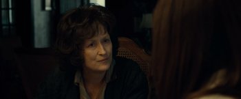 Movie still from “August: Osage County” (2013), directed by John Wells – An older woman sitting in a chair looking at the camera; Close Up shot, Over the shoulder angle