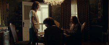 Movie still from “August: Osage County” (2013), directed by John Wells – A group of people sitting at a table in front of a window; Medium shot, Over the shoulder angle
