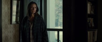 Movie still from “August: Osage County” (2013), directed by John Wells – A woman standing in front of a large window; Medium shot, Over the shoulder angle