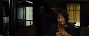 Movie still from “August: Osage County” (2013), directed by John Wells – A woman sitting at a table in front of a mirror; Medium shot, Over the shoulder angle