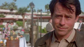 Movie still from “Auto Focus” (2002), directed by Paul Schrader – A person wearing a brown jacket; Close Up shot, Over the shoulder angle