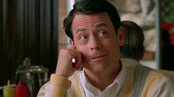 Movie still from “Auto Focus” (2002), directed by Paul Schrader – A person with his hand to his face; Close Up shot, Low angle