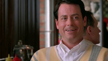 Movie still from “Auto Focus” (2002), directed by Paul Schrader – A man smiling for the camera while wearing a white shirt; Close Up shot, Over the shoulder angle