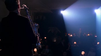 Movie still from “Auto Focus” (2002), directed by Paul Schrader – A saxophone in the middle of a dark room; Medium shot, Over the shoulder angle