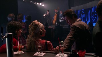 Movie still from “Auto Focus” (2002), directed by Paul Schrader – A man and a woman sitting at a bar; Medium shot, Over the shoulder angle