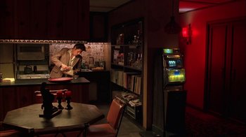 Movie still from “Auto Focus” (2002), directed by Paul Schrader – A man in a suit and tie in front of a bar; Wide shot, High angle