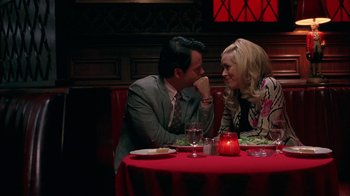 Movie still from “Auto Focus” (2002), directed by Paul Schrader – A man and a woman sitting at a table; Medium shot, Overhead angle