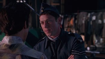 Movie still from “Auto Focus” (2002), directed by Paul Schrader – A man in a uniform is looking at the camera; Close Up shot, Over the shoulder angle