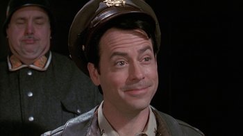 Movie still from “Auto Focus” (2002), directed by Paul Schrader – A person wearing a hat; Close Up shot, Low angle