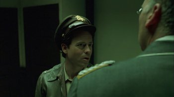 Movie still from “Auto Focus” (2002), directed by Paul Schrader – A man wearing a hat looking into a mirror; Close Up shot, Over the shoulder angle
