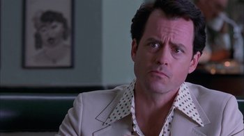 Movie still from “Auto Focus” (2002), directed by Paul Schrader – A person wearing a suit and tie; Close Up shot, Low angle