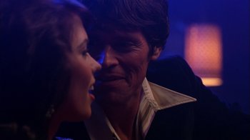 Movie still from “Auto Focus” (2002), directed by Paul Schrader – A man and a woman are looking at one another; Close Up shot, Over the shoulder angle