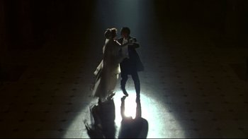 Movie still from “Avalon” (1990), directed by Barry Levinson – A man and a woman are dancing in the dark; Wide shot, Overhead angle