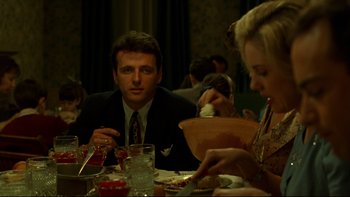 Movie still from “Avalon” (1990), directed by Barry Levinson – A man and a woman sitting at a dinner table; Medium shot, Over the shoulder angle