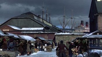 Movie still from “Avalon” (1990), directed by Barry Levinson – A group of people standing on top of a snow covered ground; Extreme Wide shot, High angle