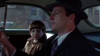 Movie still from “Avalon” (1990), directed by Barry Levinson – A man and a child in a car; Close Up shot, Over the shoulder angle