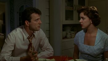 Movie still from “Avalon” (1990), directed by Barry Levinson – A man and a woman sitting at a dinner table; Medium shot, Over the shoulder angle