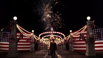 Movie still from “Avalon” (1990), directed by Barry Levinson – A man standing in front of fireworks at night; Extreme Wide shot, High angle