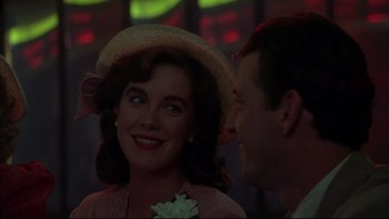 Movie still from “Avalon” (1990), directed by Barry Levinson – A man and a woman wearing a straw hat; Close Up shot, Over the shoulder angle