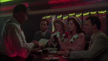 Movie still from “Avalon” (1990), directed by Barry Levinson – A group of people sitting around a table; Medium shot, Over the shoulder angle