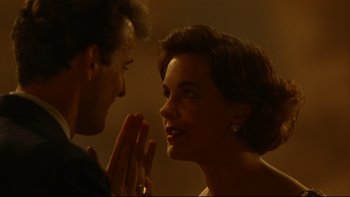 Movie still from “Avalon” (1990), directed by Barry Levinson – A man and a woman are praying together; Close Up shot, Over the shoulder angle