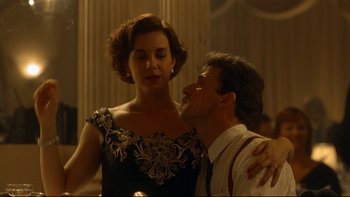 Movie still from “Avalon” (1990), directed by Barry Levinson – A man and a woman standing next to each other; Medium shot, Low angle