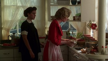 Movie still from “Avalon” (1990), directed by Barry Levinson – Two women standing in a kitchen preparing a meal; Medium shot, Over the shoulder angle