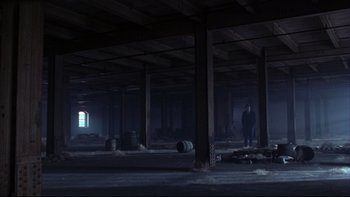 Movie still from “Avalon” (1990), directed by Barry Levinson – Two men standing in an empty warehouse; Extreme Wide shot, High angle