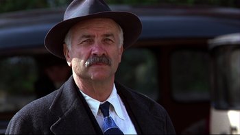 Movie still from “Avalon” (1990), directed by Barry Levinson – An older man wearing a hat and a tie; Close Up shot, Low angle