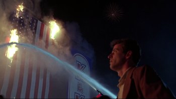 Movie still from “Avalon” (1990), directed by Barry Levinson – A man standing in front of a fire hydrant at night; Medium shot, Low angle