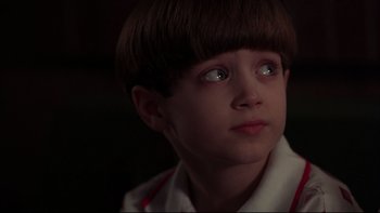 Movie still from “Avalon” (1990), directed by Barry Levinson – A young boy with short brown hair looking up at the sky; Close Up shot, High angle