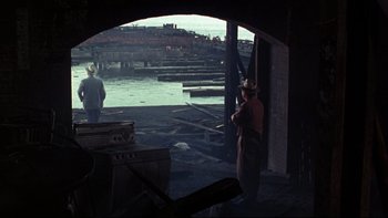 Movie still from “Avalon” (1990), directed by Barry Levinson – Two men standing on a dock looking out over the water; Wide shot, Over the shoulder angle