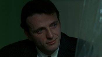 Movie still from “Avalon” (1990), directed by Barry Levinson – A person wearing a suit and tie; Close Up shot, Over the shoulder angle