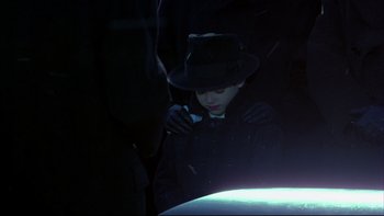 Movie still from “Avalon” (1990), directed by Barry Levinson – A young boy wearing a hat and holding a flashlight; Medium shot, High angle